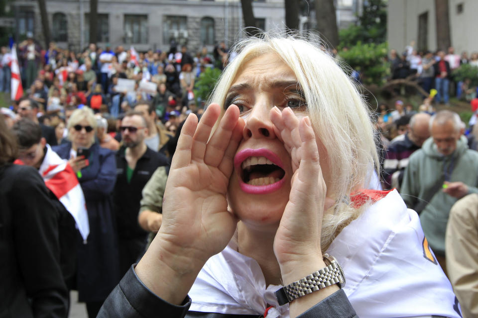 A demonstrator shouts in front of police during an opposition protest against the foreign influence bill at the Parliamentary building in Tbilisi, Georgia, Tuesday, May 28, 2024. (AP Photo/Shakh Aivazov)