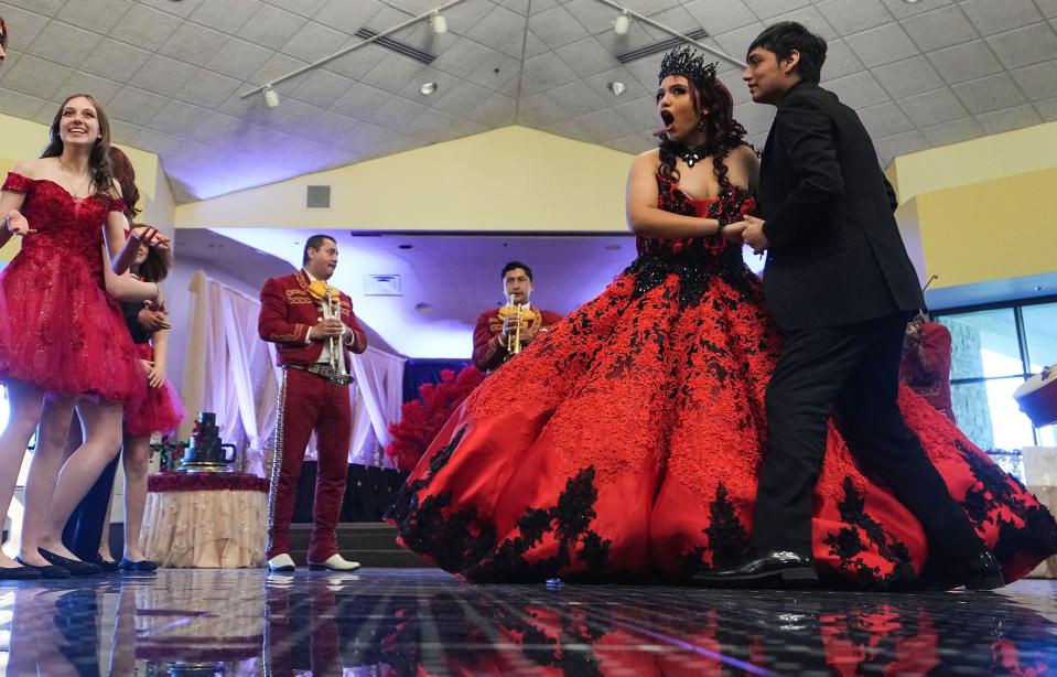 Kimberly Reyna, 16, talks to a friend while dancing during her quinceañera on Saturday, April 8, 2023 at Grand Hall in Indianapolis.