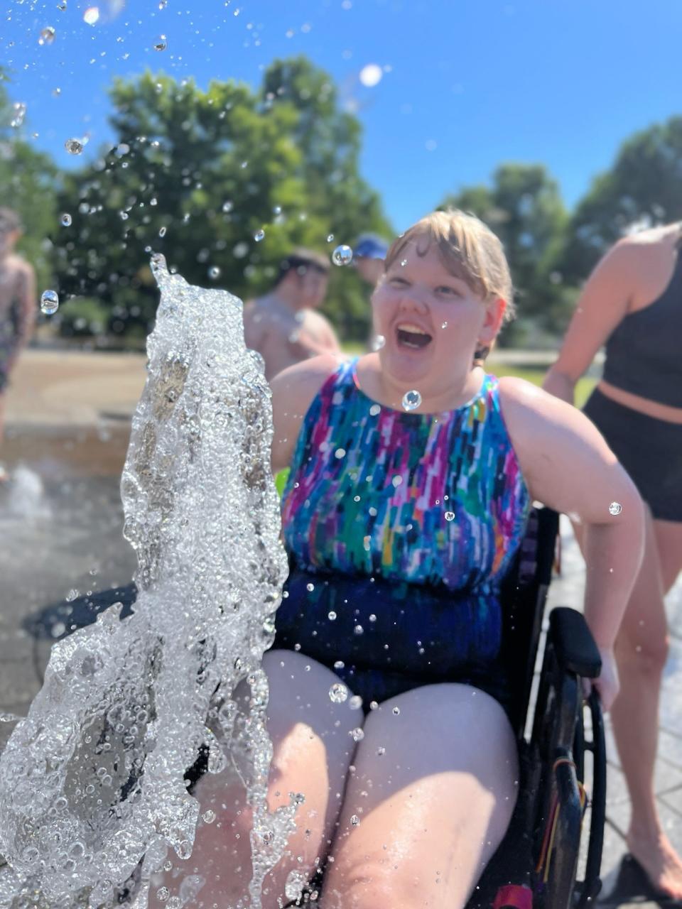 Claire Dula, 16, laughs as a fountain sprays water during an outing during the Arc of the Ozarks summer program. Claire has attended the summer program since she was 7 years old, said her mom, Rebecca Dula, and "every year, she looks forward to" going to Arc of the Ozarks' summer camp.