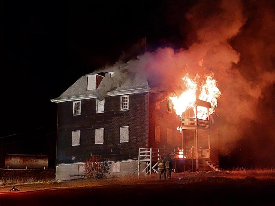 A fire destroyed the abandoned priests rectory in Fort Chipewyan, Alta. (Submitted/Paul Grandjambe Tuccaro - image credit)