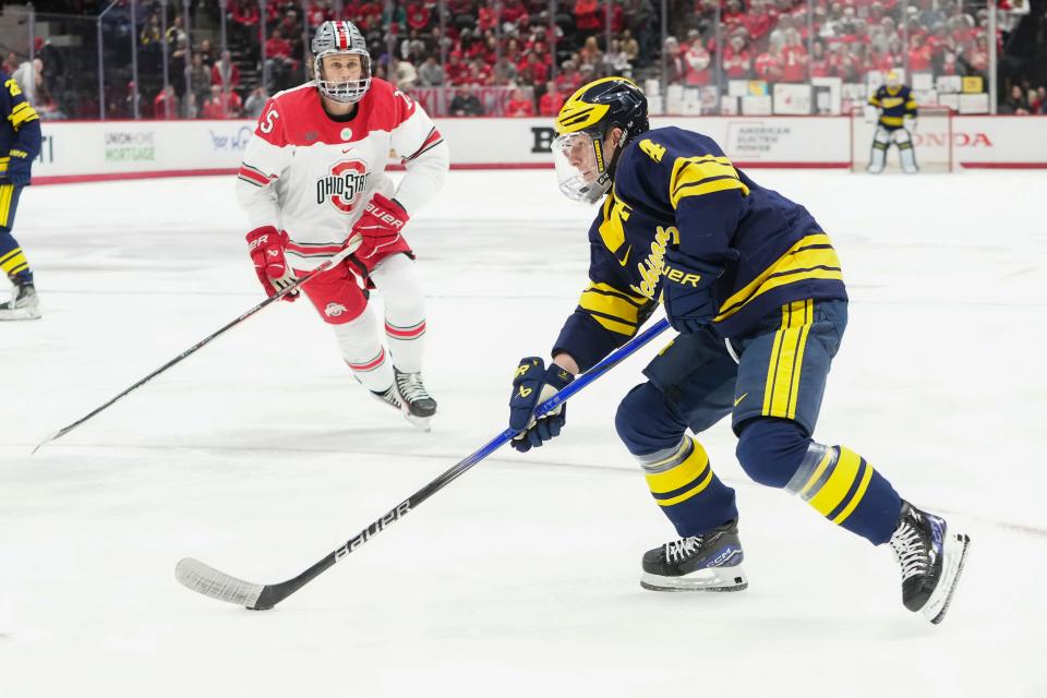 Feb 2, 2024; Columbus, Ohio, USA; Michigan Wolverines forward Gavin Brindley (4) skates past Ohio State Buckeyes forward Cam Thiesing (15) during the NCAA men’s hockey game at Value City Arena.