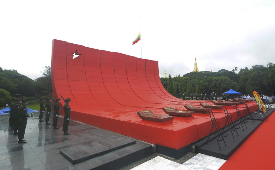 In this handout image provided by the Myanmar Ministry of Information, soldiers stand at attention during a ceremony to mark the 75th anniversary of his 1947 assassination, at the Martyrs' Mausoleum Tuesday, July 19, 2022, in Yangon, Myanmar. Myanmar's military-ruled government and its opponents on Tuesday marked the 75th anniversary of the assassination of independence hero Gen. Aung San, the father of the country's ousted leader, Aung San Suu Kyi. (Myanmar Ministry of Information via AP)