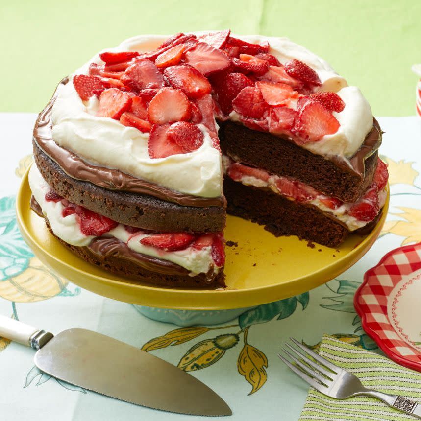 chocolate strawberry nutella cake on yellow cake stand