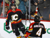 Calgary Flames forward Nazem Kadri, left, celebrates his goal with teammate Rasmus Andersson during the third period of an NHL hockey game against the Arizona Coyotes in Calgary, Alberta, Monday, Dec. 5, 2022. (Jeff McIntosh/The Canadian Press via AP)