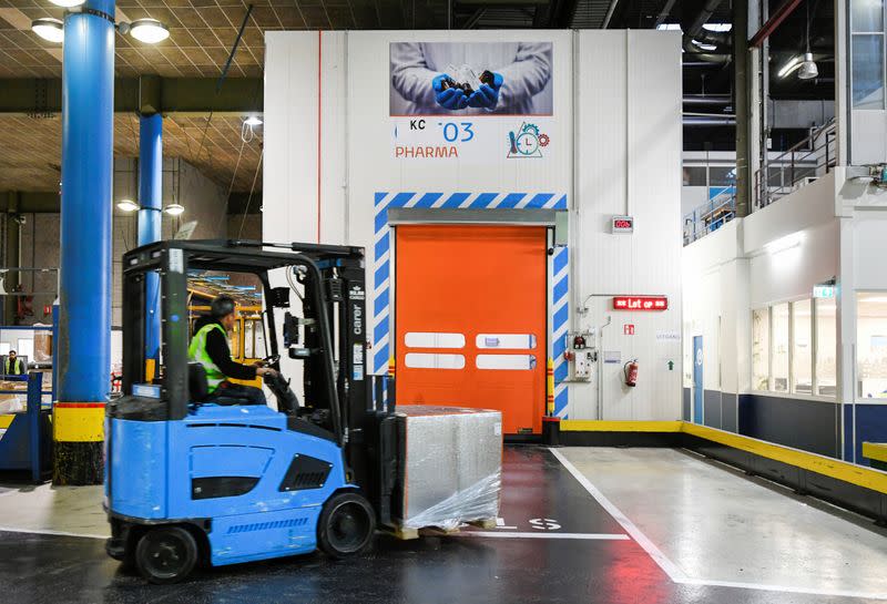 A KLM worker is entering a cold room by a forklift truck at Amsterdam's Schiphol Airport