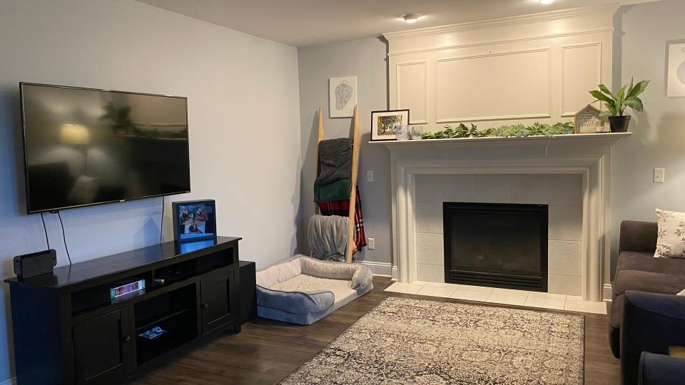 white fireplace and mounted tv in living room