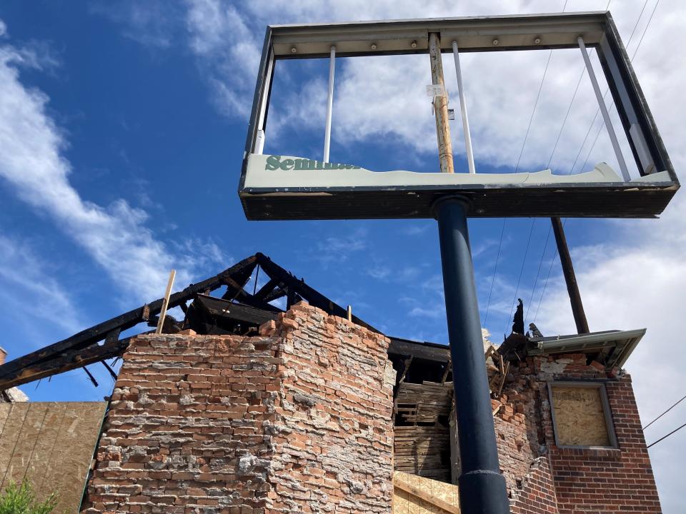 A scorched sign outside the Albany Building at 125 E. Seventh St. on June 15, 2023, in Pueblo, Colo.