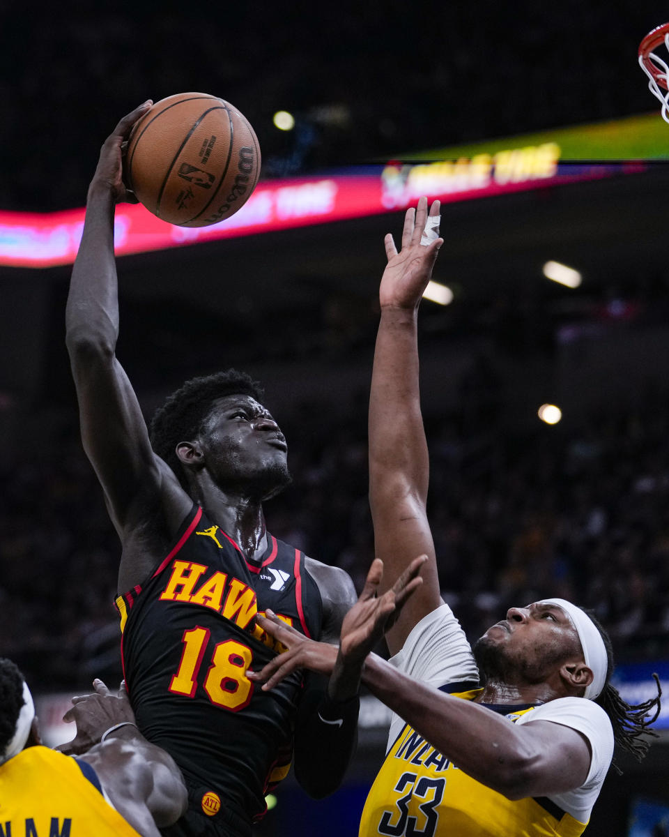 Atlanta Hawks forward Mouhamed Gueye (18) shoots over Indiana Pacers center Myles Turner (33) during the first half of an NBA basketball game in Indianapolis, Sunday, April 14, 2024. (AP Photo/Michael Conroy)