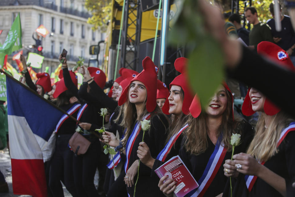 Conservative activists gather to protest in Paris, Sunday Oct. 6, 2019, against a French bill that would give lesbian couples and single women access to in vitro fertilization and related procedures. Traditional Catholic groups and far-right activists organized Sunday's protest, arguing that it deprives children of the right to a father. (AP Photo/Rafael Yaghobzadeh)