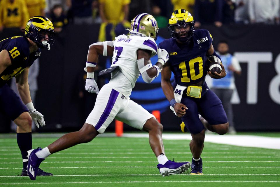 Jan 8, 2024; Houston, TX, USA; Michigan Wolverines quarterback Alex Orji (10) runs the ball against Washington Huskies cornerback Dominique Hampton (7) during the second quarter in the 2024 College Football Playoff national championship game at NRG Stadium. Mandatory Credit: Troy Taormina-USA TODAY Sports