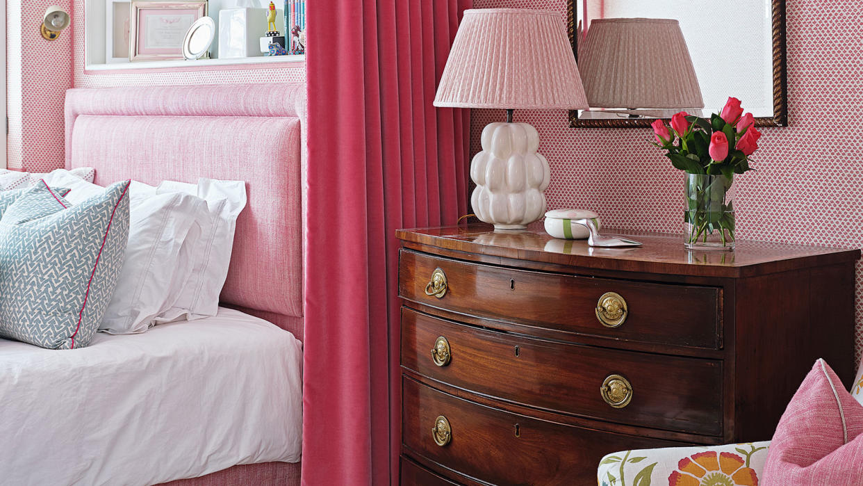  pink bedroom with wooden chest of drawers 