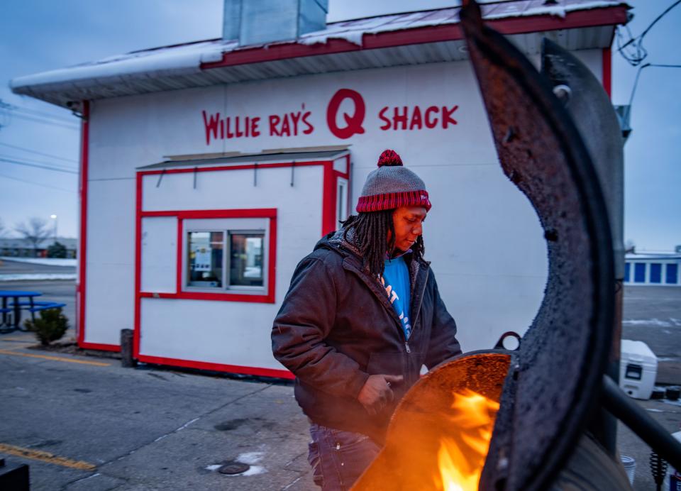 Willie Ray Fairley, the owner of Willie Ray's Q Shack, lights the grills as the sun rises over Cedar Rapids last November.