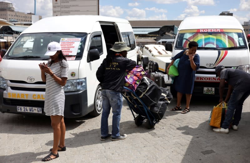 A man carries luggage on a trolley as residents of a number of African cities where the coronavirus is spreading are heading to the countryside to try to escape from the disease, in Johannesburg