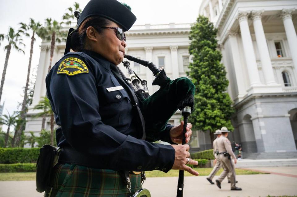 Lorie Tubil, with the Los Angeles Police Department Emerald Society Pipes and Drums, warms up her bag pipes on Monday during the California Peace Officers’ Memorial Ceremony at the state Capitol.