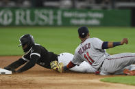 Chicago White Sox's Luis Robert left, is tagged out by Minnesota Twins second baseman Jorge Polanco (11) while trying to steal second base during the first inning of a baseball game Tuesday, July 5, 2022, in Chicago. (AP Photo/Paul Beaty)