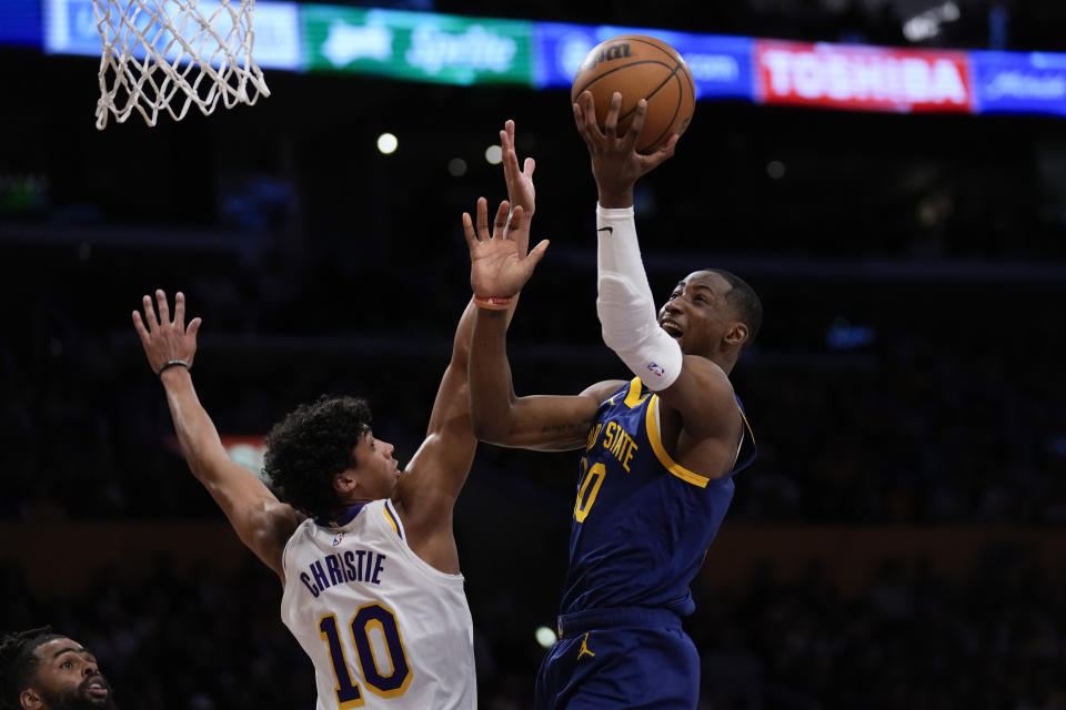 Golden State Warriors forward Jonathan Kuminga (00) shoots against Los Angeles Lakers guard Max Christie (10) during the first half of an NBA basketball game in Los Angeles, Saturday, March 16, 2024. (AP Photo/Ashley Landis)