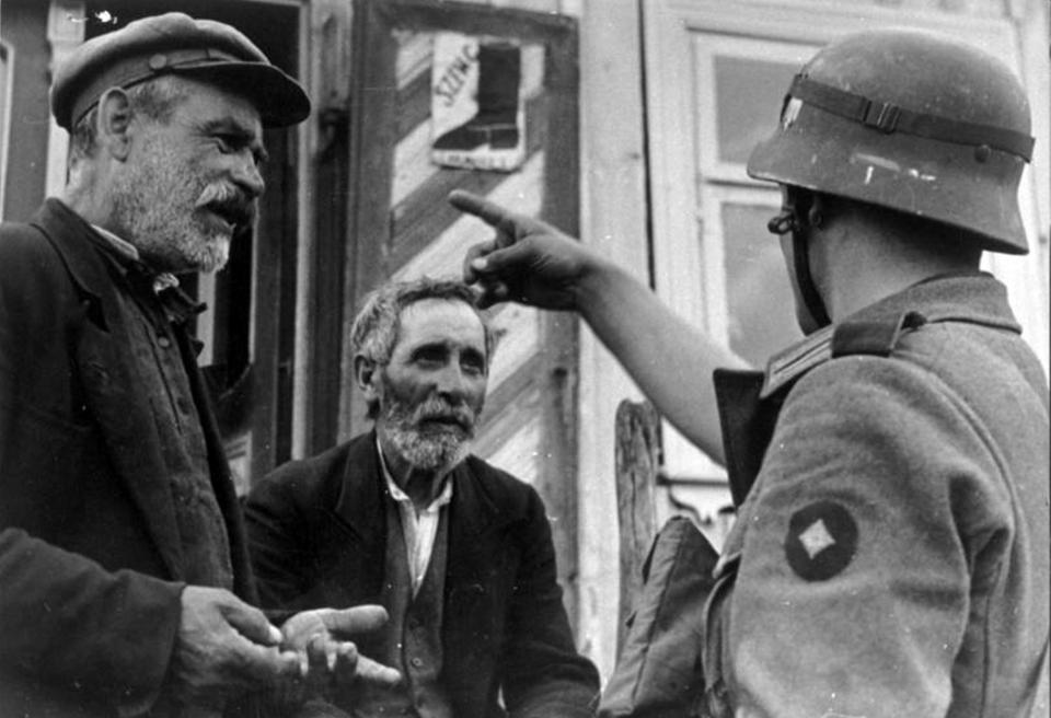 Image: Lithuanian Jews and a German Wehrmacht Soldier during the Holocaust (Universal History Archive / via Getty Images)