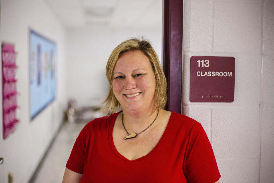 In this Oct. 13, 2018 photo made available by Robert Osborne, Jenny Urie stands near a classroom in Kentucky. Urie and 36 current and former educators ran for a seat in the Kentucky legislature, two-thirds of them lost. Months after massive teacher walkouts energized many like never before, teachers and their unions are coming to terms with the midterm elections' mix of wins and losses. (Robert Osborne via AP)