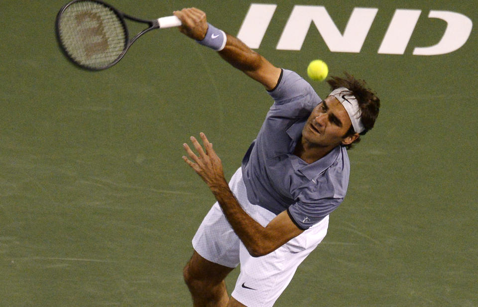 Roger Federer, of Switzerland, serves to Kevin Anderson, of South Africa, during their quarterfinal match at the BNP Paribas Open tennis tournament on Thursday, March 13, 2014, in Indian Wells, Calif. (AP Photo/Mark J. Terrill)