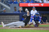Chicago White Sox's Korey Lee scores next to Toronto Blue Jays catcher Danny Jansen during the second inning of a baseball game Tuesday, May 21, 2024, in Toronto. (Christopher Katsarov/The Canadian Press via AP)