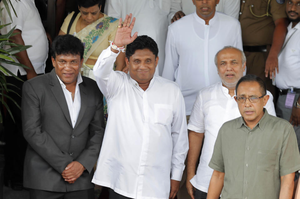 Presidential candidate of Sri Lanka's governing United National Party, Sajith Premadasa waves to media as he leaves the election commission after filing his nomination with his supporters in Colombo, Sri Lanka, Monday, Oct. 7, 2019. Premadasa is a son of former President Ranasinghe Premadasa, who was assassinated in 1993 by the Tamil Tiger rebels. The rebels were eventually defeated in the civil war. (AP Photo/Eranga Jayawardena)