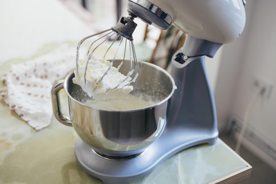 White KitchenAid stand mixer whipping batter