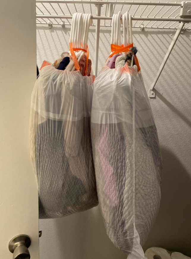 clothes in bags on hangers