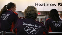 Olympic volunteers wait to greet arriving teams at Heathrow Airport on July 16, 2012 in London, England. Athletes, coaches and Olympic officials are beginning to arrive in London ahead of the Olympics. (Photo by Peter Macdiarmid/Getty Images)