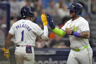 Tampa Bay Rays' Harold Ramírez celebrates with Richie Palacios (1) after scoring on a bases-loaded walk by San Francisco Giants pitcher Keaton Winn during the second inning of a baseball game Friday, April 12, 2024, in St. Petersburg, Fla. (AP Photo/Chris O'Meara)