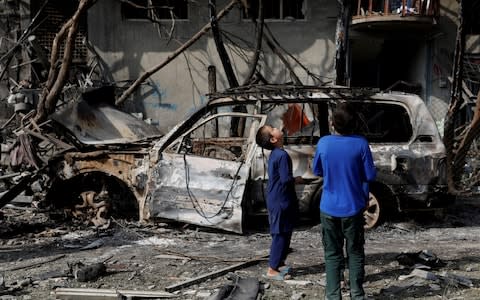 Afghan boys look the site of Sunday's attack in Kabul, Afghanistan July 29, 2019. REUTERS/Mohammad Ismail TPX IMAGES OF THE DAY - Credit: Reuters