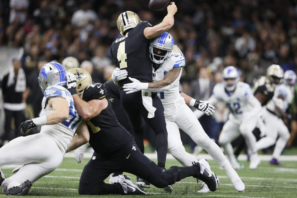 Detroit Lions linebacker Bruce Irvin (51) tackles New Orleans Saints quarterback Derek Carr (4) causing an injury during the second half of an NFL football game, Sunday, Dec. 3, 2023, in New Orleans. (AP Photo/Butch Dill)