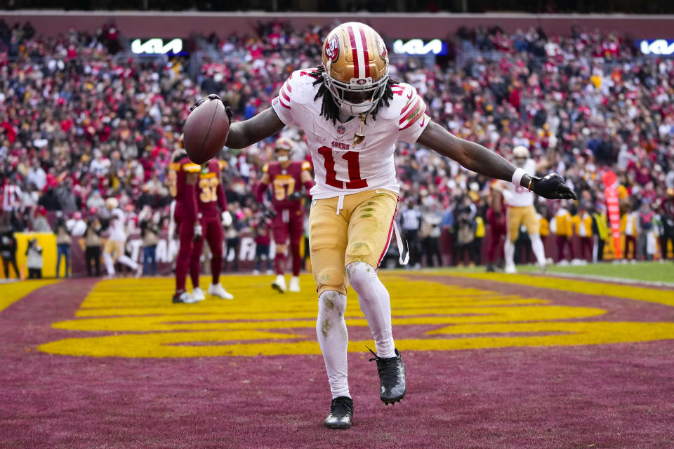 San Francisco 49ers wide receiver Brandon Aiyuk (11) celebrates his touchdown against the Washington Commanders during the second half of an NFL football game, Sunday, Dec. 31, 2023, in Landover, Md. (AP Photo/Alex Brandon)