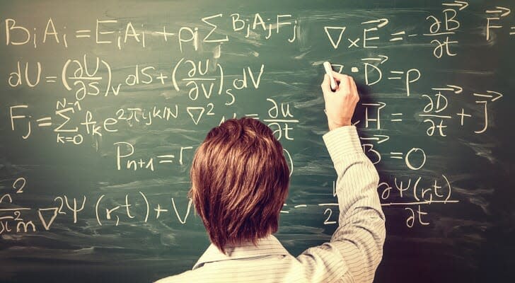 Man doing mathematics on a chalk board