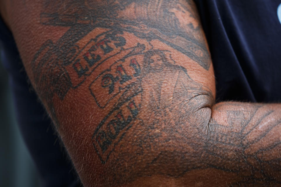 <p>An audience member with a “Let’s Roll” tattoo stands for the national anthem during the September 11th Flight 93 Memorial Service, Tuesday, Sept. 11, 2018, in Shanksville, Pa. (Photo: Evan Vucci/AP) </p>