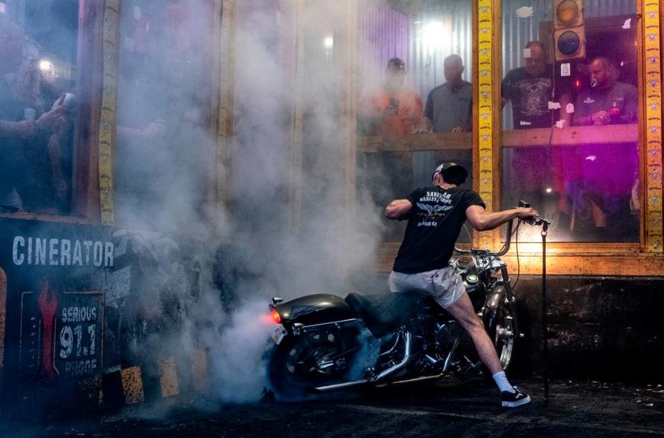 Bikers compete in the burnout pit at Suck Bang Blow bar in Murrells Inlet, S.C. during the 2024 Myrtle Beach Spring Rally. Their spinning tires burn rubber often shredding tires and filling the air with smoke, the roar of engines and the cheers from the crowd. May 16, 2024.