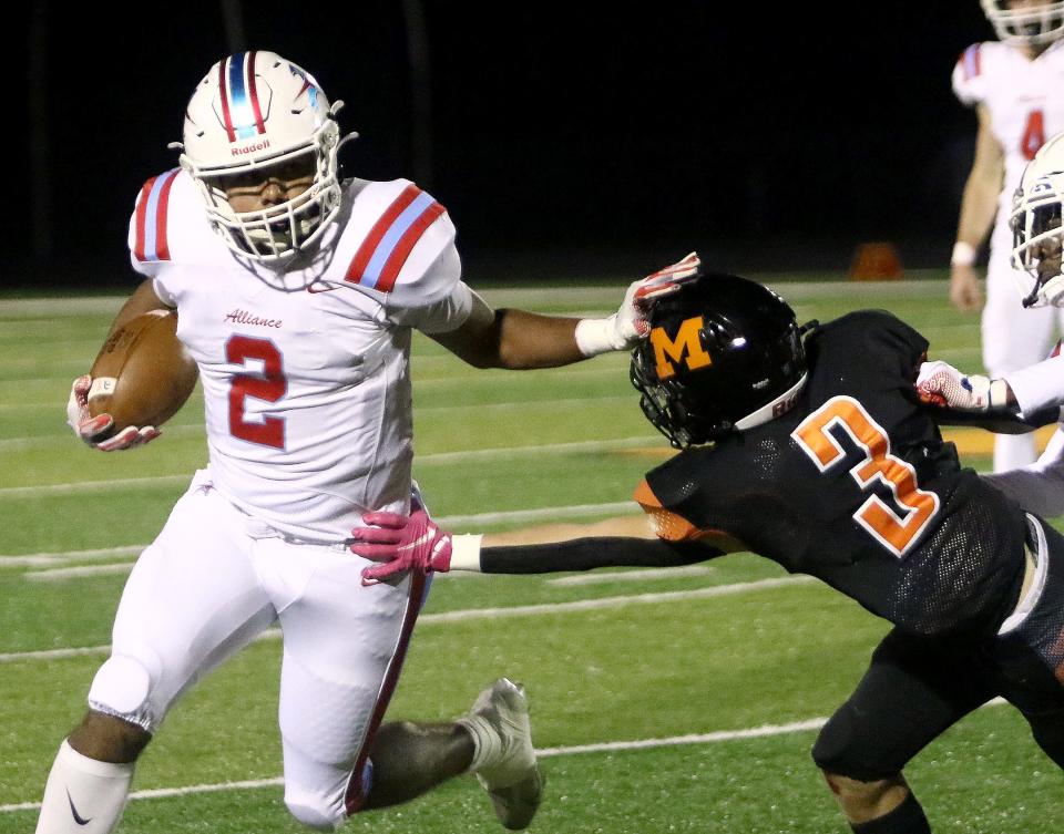 Marlington's Ty Knoch goes for a tackle against Alliance's Kayden Davis during last season's rivalry game.