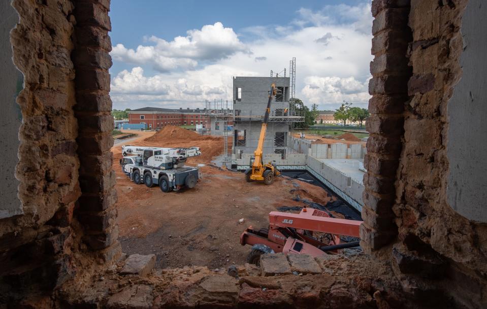 June 27, 2022; Tuscaloosa, AL, USA; Work on the new east wing that is going up at Bryce Main is seen through a window of the central building. The original wing had to be demolished due to structural flaws.  Gary Cosby Jr.-The Tuscaloosa News