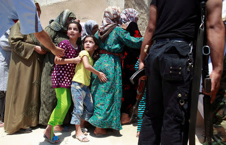 FILE PHOTO: Girls queue to buy bread at the only bakery serving the outskirts of Idlib province, Syria August 1, 2012. REUTERS/Zohra Bensemra/File Photo