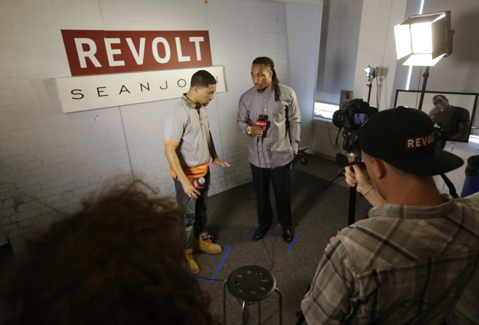 This May 6, 2014 photo shows NFL Draft prospect Calvin Pryor, a safety from Louisville, right, listening to a question during an interview with Revolt TV host Lawrence Jackson at the 5th Annual NFL Pre-Draft Gifting & Style Suite at the Sean John show room in New York. (AP Photo/Frank Franklin II)