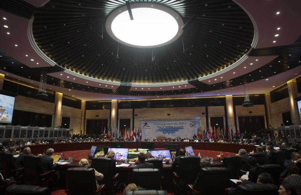 Heads of state from Europe and Asia together with President of the European Council, European Commission and Secretary-General of ASEAN attend first plenary session during the ASEM Summit in Vientiane, Laos, Monday, Nov. 5, 2012. (AP Photo/Sakchai Lalit)