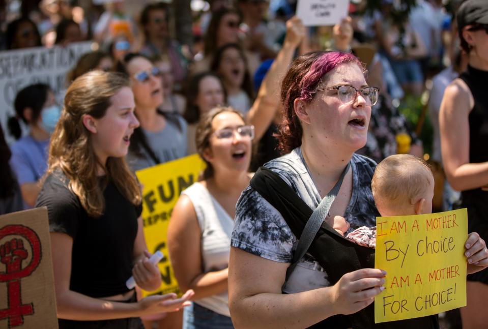 FILE - Attendees react to speakers during an abortions rights rally in response to the U.S. Supreme Court decision overturning Roe v. Wade on Saturday, June 25, 2022 in downtown Athens.