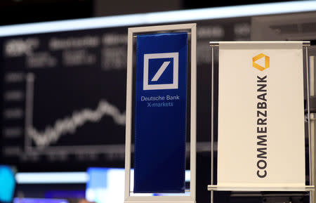 FILE PHOTO: Banners of Deutsche Bank and Commerzbank are pictured in front of the German share price index, DAX board, at the stock exchange in Frankfurt, Germany, September 30, 2016. REUTERS/Kai Pfaffenbach/File Photo