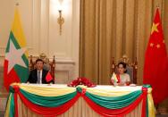 Chinese President Xi Jinping and Myanmar State Counselor Aung San Suu Kyi attend a signing ceremony of a memorandum of understanding (MOU) at the Presidential Palace in Naypyitaw