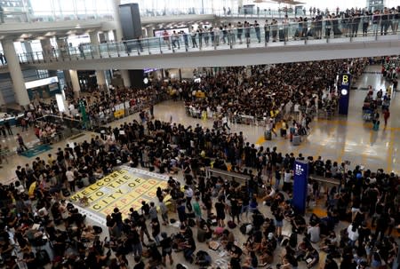 Anti-extradition bill demonstrators attend a protest at the arrival hall of Hong Kong Airport