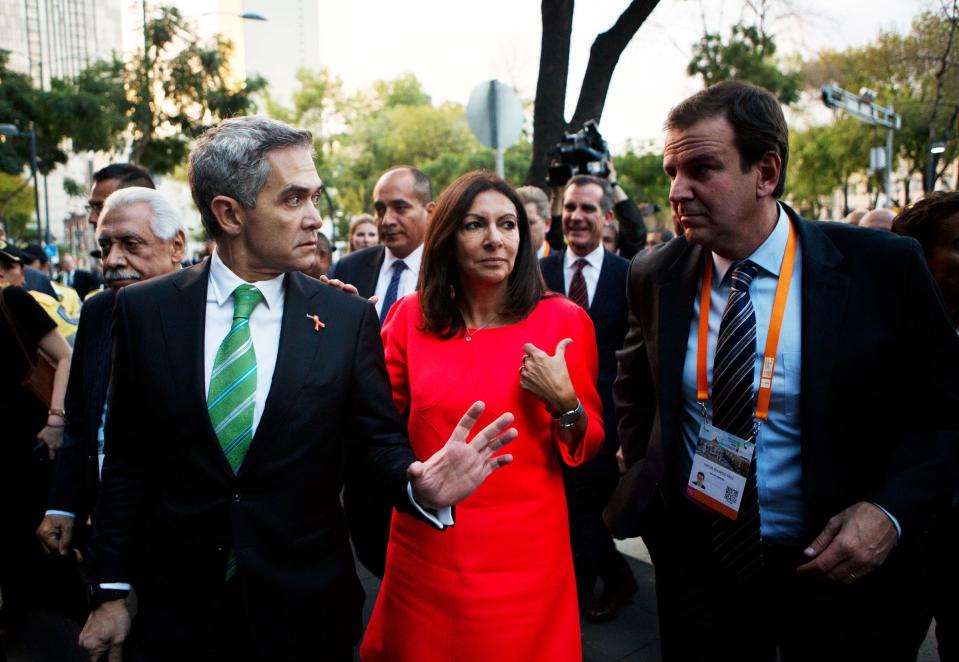 Mexico City Mayor Miguel Angel Mancera, left, speaks with Paris Mayor Anne Hidalgo, center, and Rio de Janeiro Mayor Eduardo Paes who is also C40 chair, as they arrive for the opening ceremony of the C40 Mayors Summit in Mexico City, Wednesday, Nov. 30, 2016. The Nov. 30 to Dec. 2. summit is focusing on an agenda of climate action and inclusive urban growth. (AP Photo/Rebecca Blackwell)