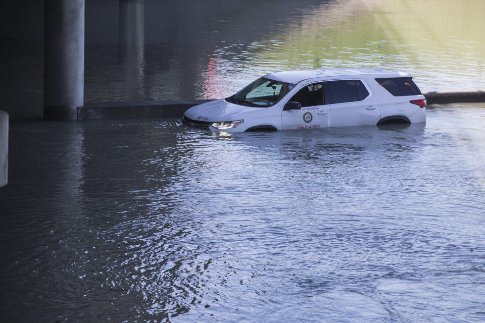 An abandoned vehicle sits stalled in floodwaters from a water main break that inundated the East Loop 610 on Thursday, Feb. 27, 2020 in Houston. The flooding closed the major freeway that circles the city. ( Brett Coomer/Houston Chronicle via AP)