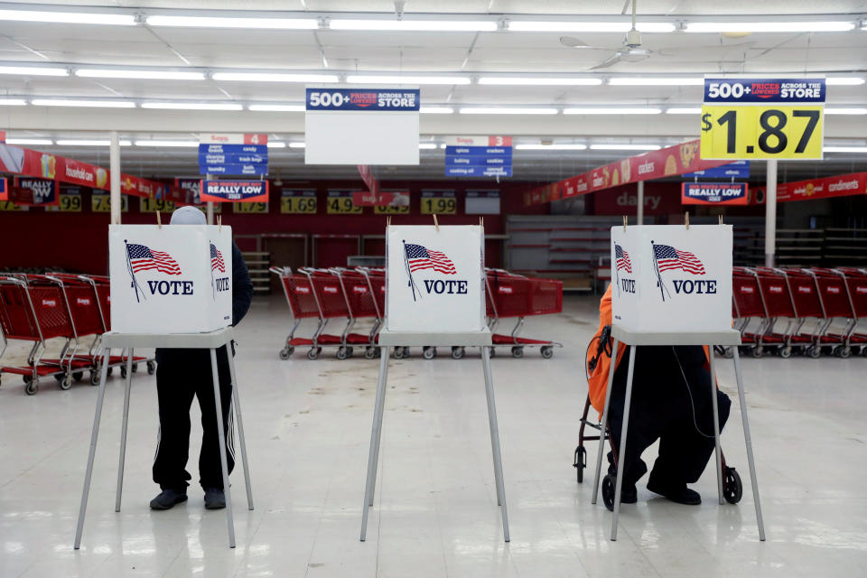 Voters fill out ballots during the primary election in Ottawa, Illinois, U.S., March 17, 2020. The polling station was relocated from a nearby nursing home to a former supermarket due to concerns over the outbreak of coronavirus (COVID-19). REUTERS/Daniel Acker     TPX IMAGES OF THE DAY