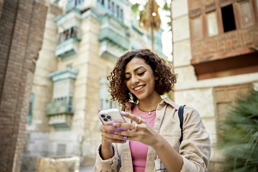 Girl looking down at iPhone.