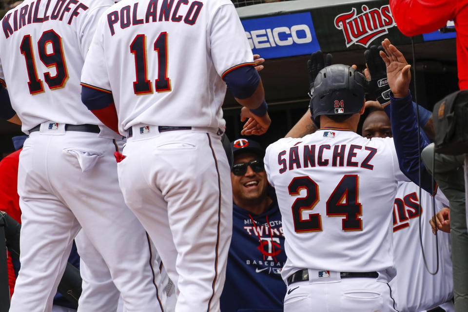 Minnesota Twins' Gary Sanchez (24) is celebrated by his team after hitting a grand slam against the Seattle Mariners during the first inning of a baseball game, Sunday, April 10, 2022, in Minneapolis. (AP Photo/Nicole Neri)