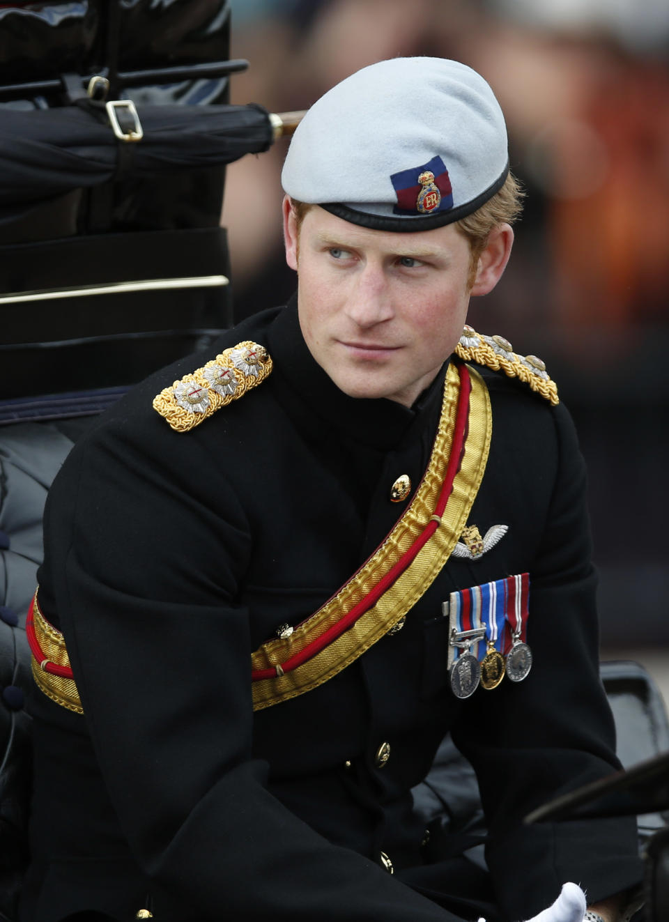 File - In this Saturday, June. 15, 2013, file photo, Britain's Prince Harry arrives back to Buckingham Palace in a horse drawn carriage after the Trooping The Colour parade, at the Horse Guards Parade in London. Palace officials say that Prince Harry is ending his role as a helicopter pilot and taking up a new job with the army in London. Kensington Palace said Harry — known in the army as Capt. Wales — will now be organizing "major commemorative events" involving the army. (AP Photo/Sang Tan, File)